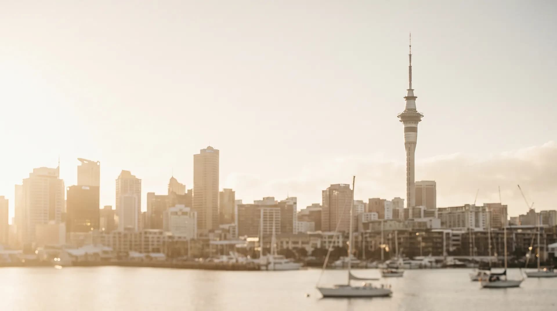The Sky Tower above the Auckland harbour at golden hour