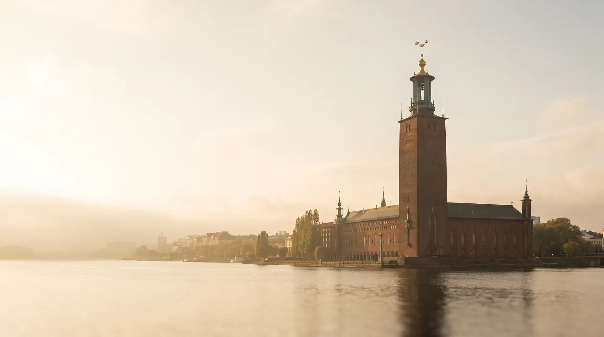 Stockholm City Hall's tower above the water at golden hour