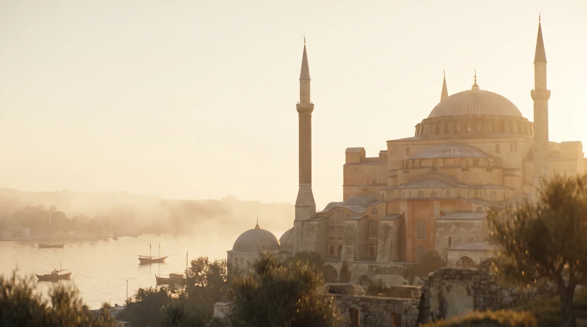 Hagia Sophia's dome and minarets above the Bosphorus in Istanbul at golden hour