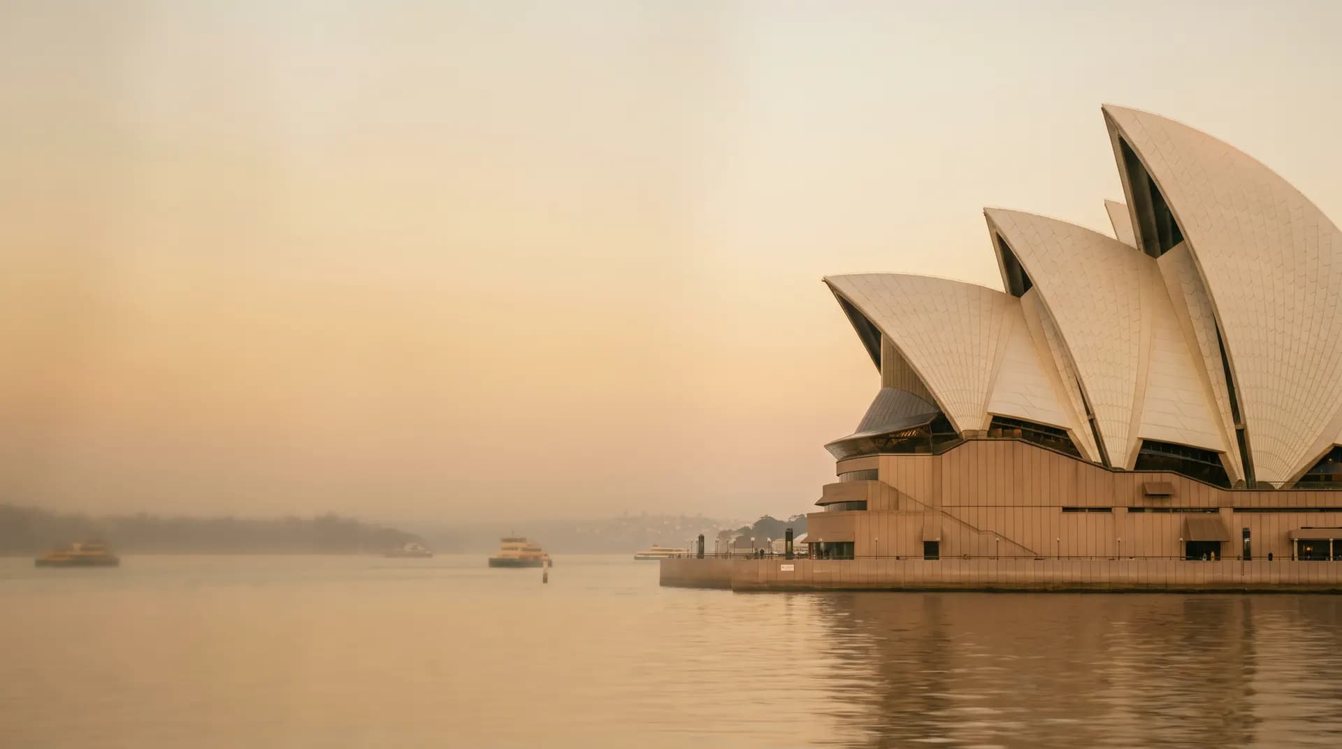The Sydney Opera House above the harbour at golden hour
