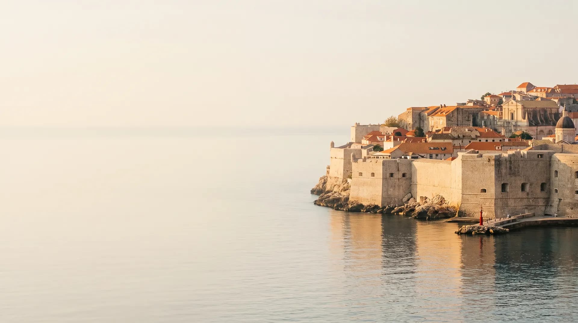 Dubrovnik's stone walls and terracotta rooftops above the Adriatic at golden hour
