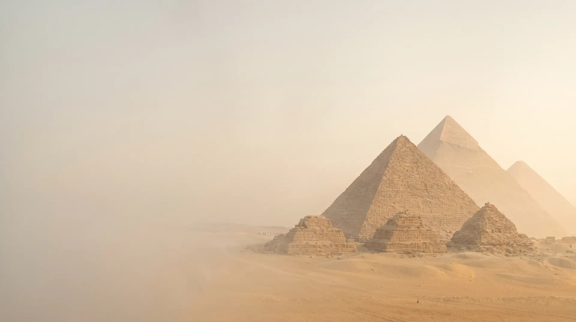 The Pyramids of Giza in desert haze at golden hour