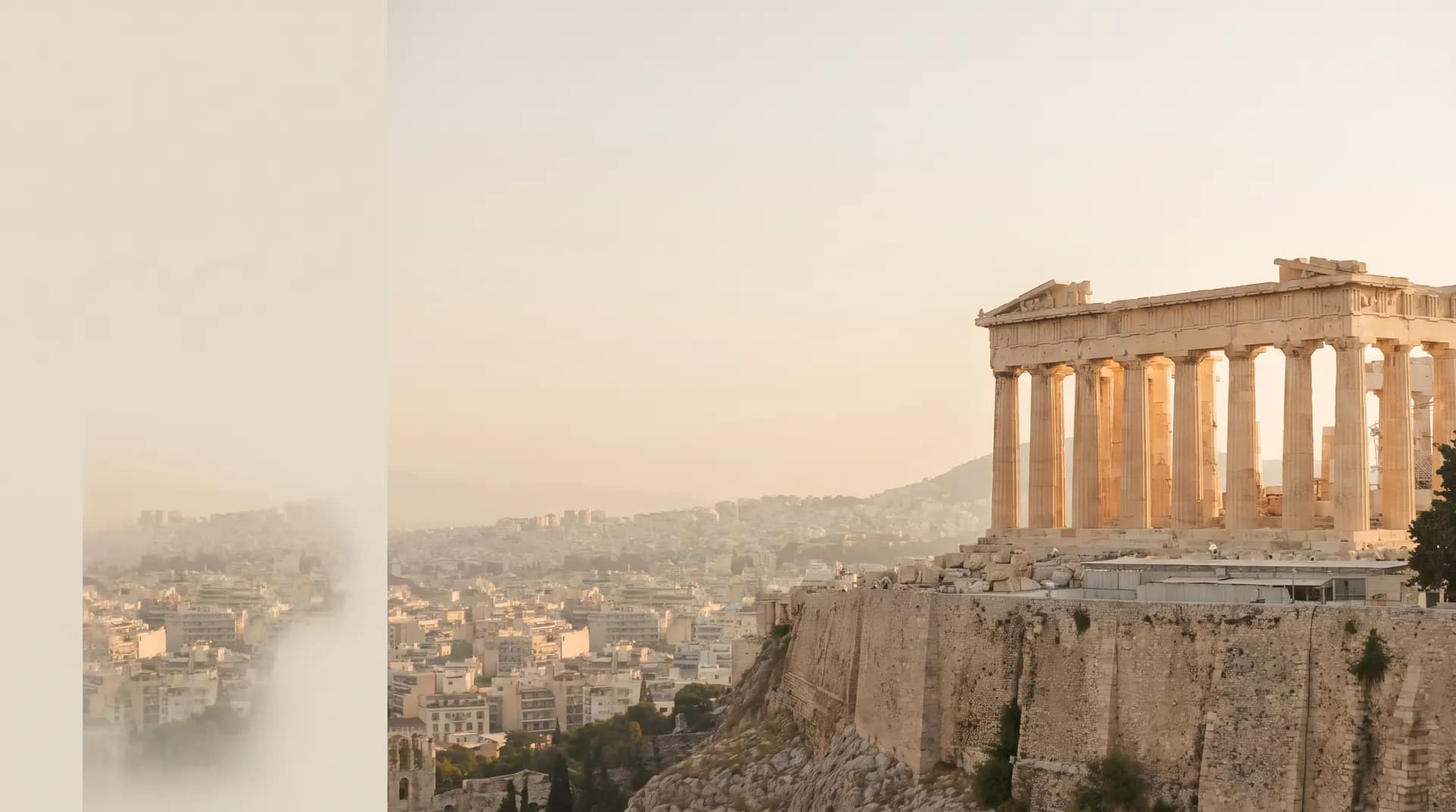 The Parthenon atop the Acropolis above hazy Athens at golden hour
