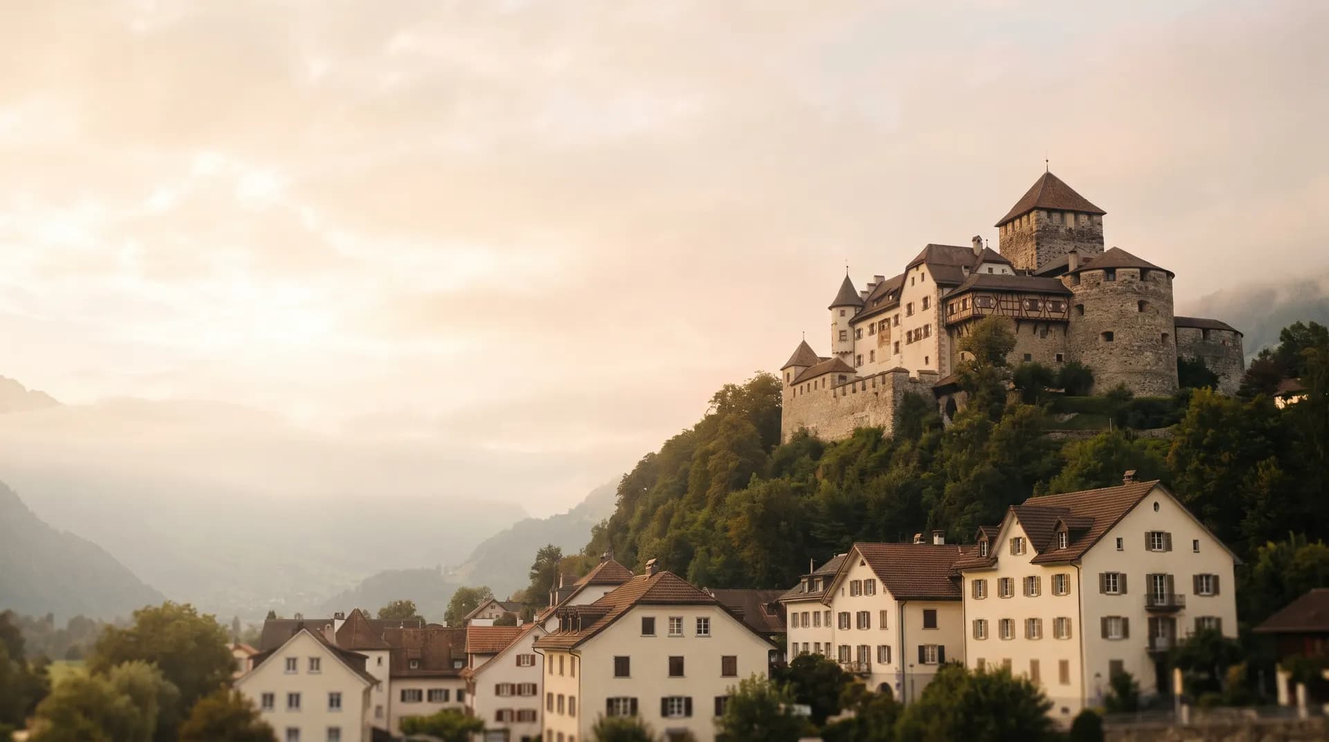 Vaduz Castle on its wooded hillside above the town at golden hour